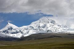 Shishapangma North 01 07 Shishapangma and Phola Gangchen From North Base Camp We drove to Shishapangma Base Camp (5000m), known locally as Chinese Base Camp, pleasantly situated on grassy patch alongside the river, raging in the monsoon. We waited a few hours, and finally the monsoon clouds lifted for a few minutes. On the left is Phola Ganchen (7661m) and to the right is Shishapangma (8012m).